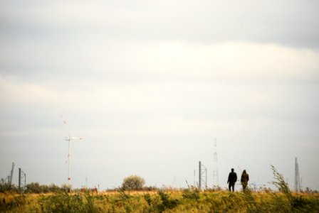 photography of two people walking on road photo