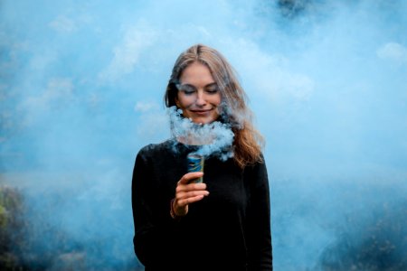 shallow focus photography of woman surrounded by smoke photo
