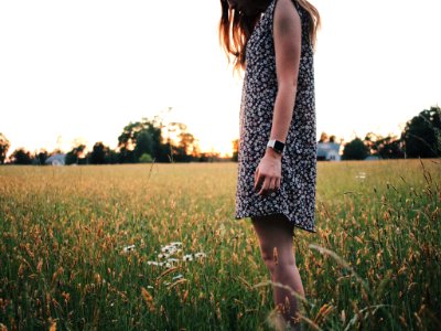 woman in black and white sleeveless dress on green grass field photo