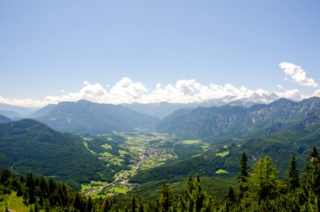 landscape photo of town surrounded by forest and mountain