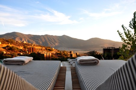 sunloungers fronting buildings near mountain photo