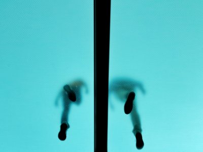 low angle photography of two people walked in glass flooring photo