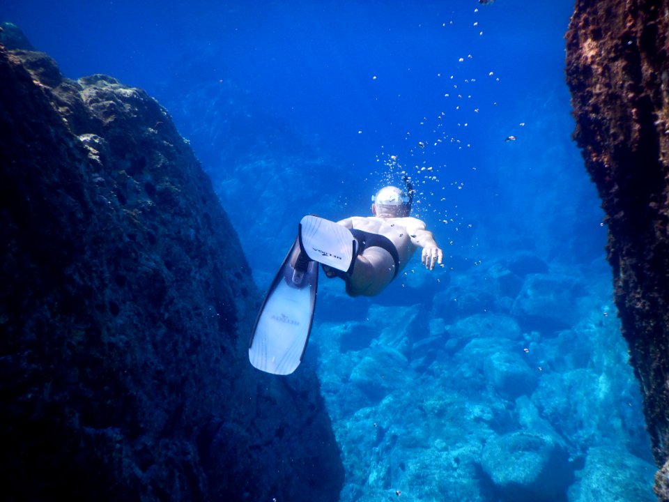 underwater photo of person wearing flippers