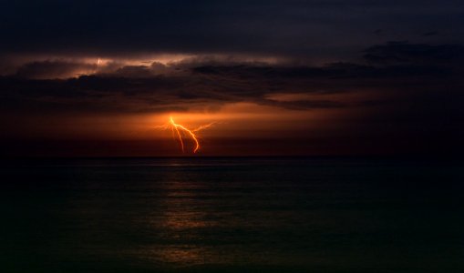 lightning in ocean during night time