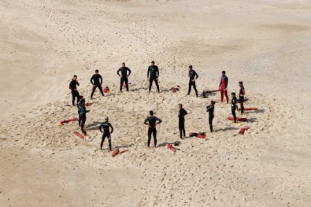people standing forming a circle during daytime photo