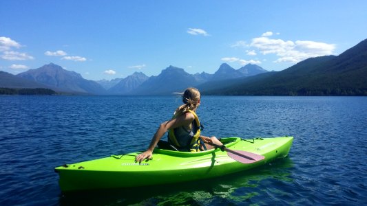 woman on kayak in the middle of body of water photo