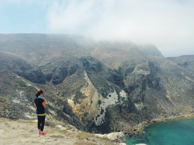 woman standing on cliff photo