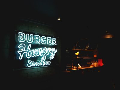 Burger Hungry neon signage mounted on white painted wall photo