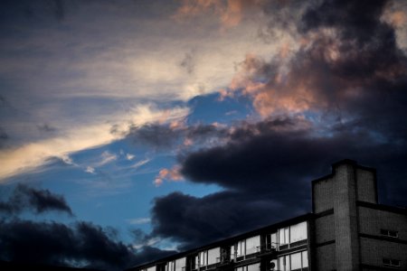 landscape photography of white building under dark cloudy sky photo