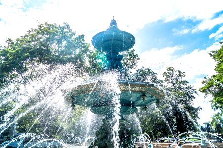 shallow focus photo of outdoor fountain under white and blue cloudy sky photo