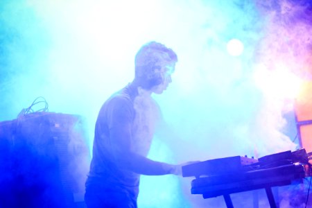 A man performing on a fog covered stage. photo