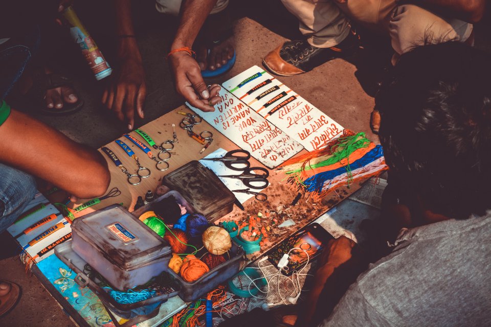 group of people making keychains