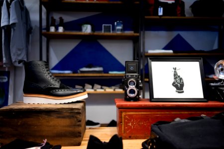 unpaired black and white leather combat boot