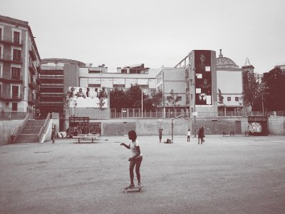 girl ride on skateboard near building photo