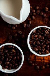 black coffee beans in ceramic mugs photo