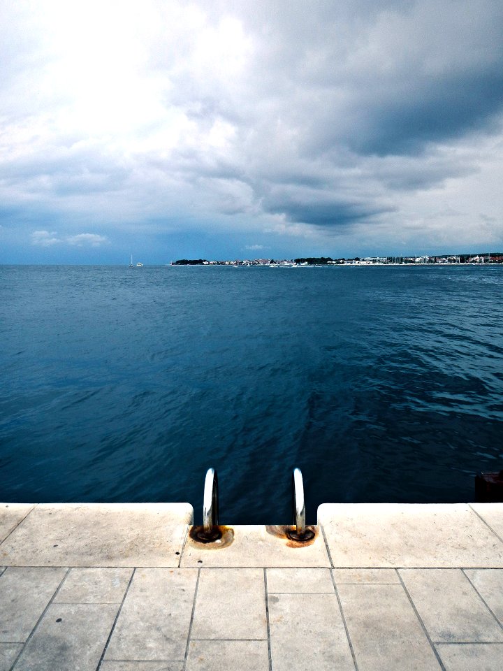 body wave of water near buildings