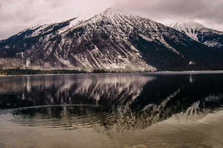 silhouette photo of lake beside mountain photo