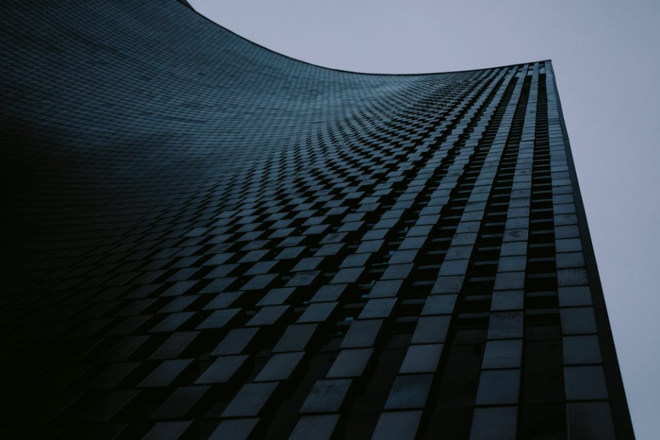 low-angle photography of high-rise building under gray sky photo