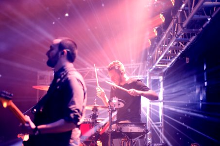 man playing drums on stage photo