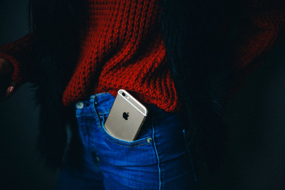 gold iPhone 6 on person's pocket