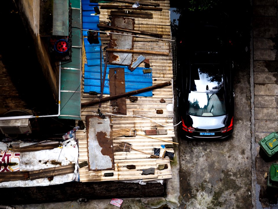bird's-eye view of black car beside house