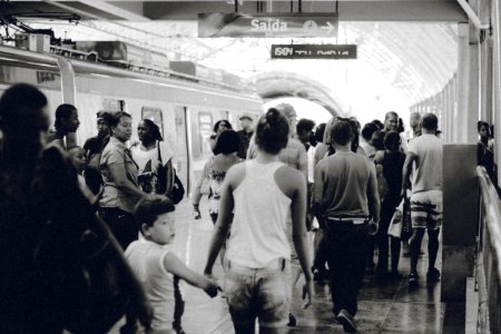 grayscaled photo of crowd on subway photo
