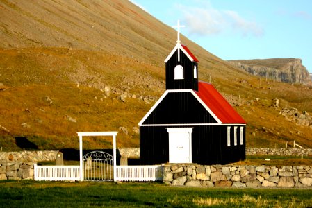 black and red church near mountain ranges photo