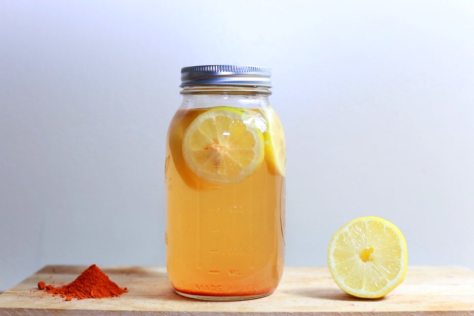 clear glass mason jar on brown surface photo