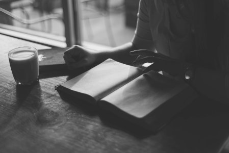 grayscale photo of person reading book photo