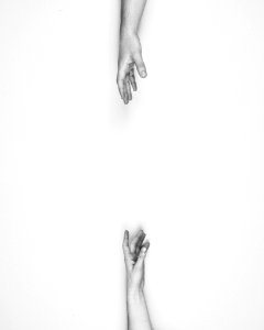 Two hands reaching for each other. photo