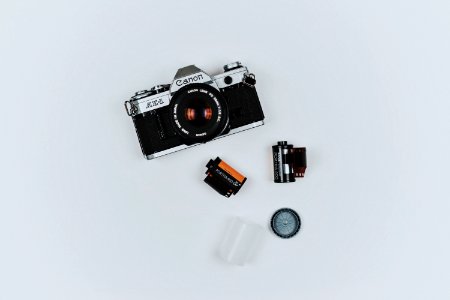 black Canon film camera with two films in flat lay photography photo