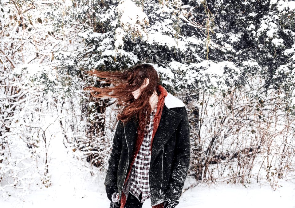 woman facing sideways with hair covering her face