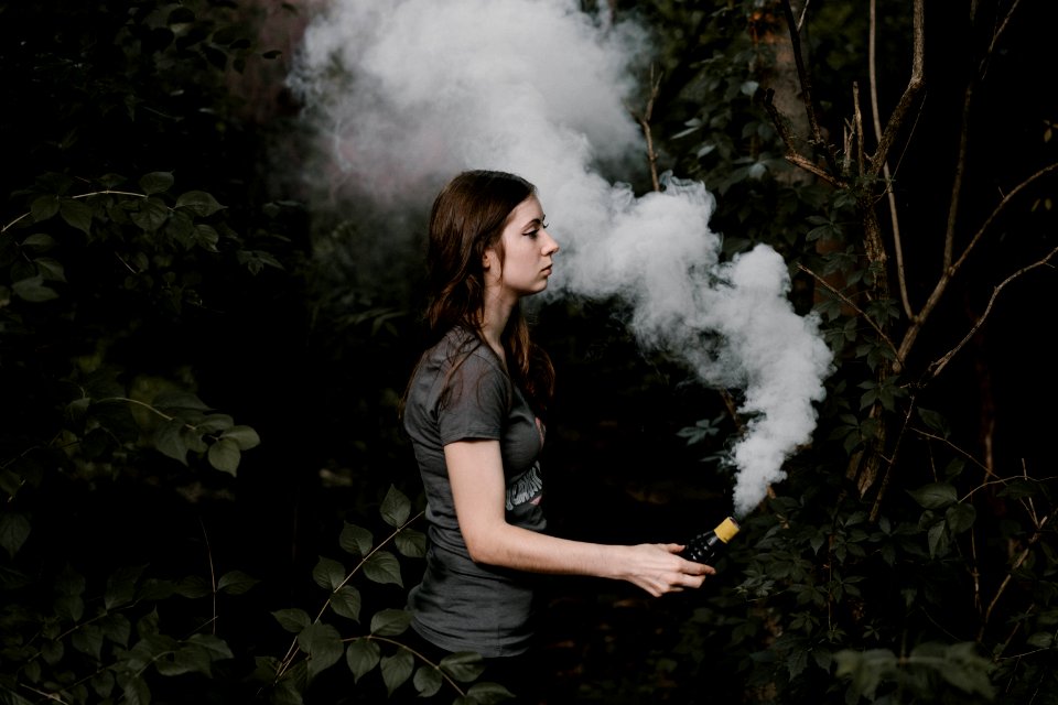 woman holding smoking bar