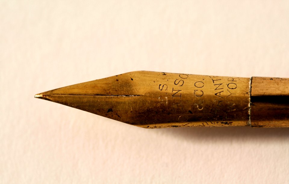 closeup photo of gold fountain pen