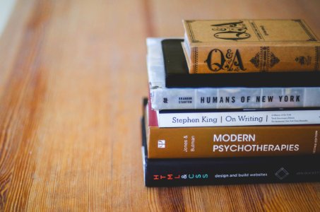 assorted reading books on table photo