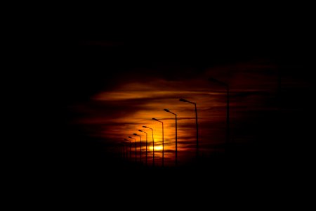 silhouette street lights during sunset