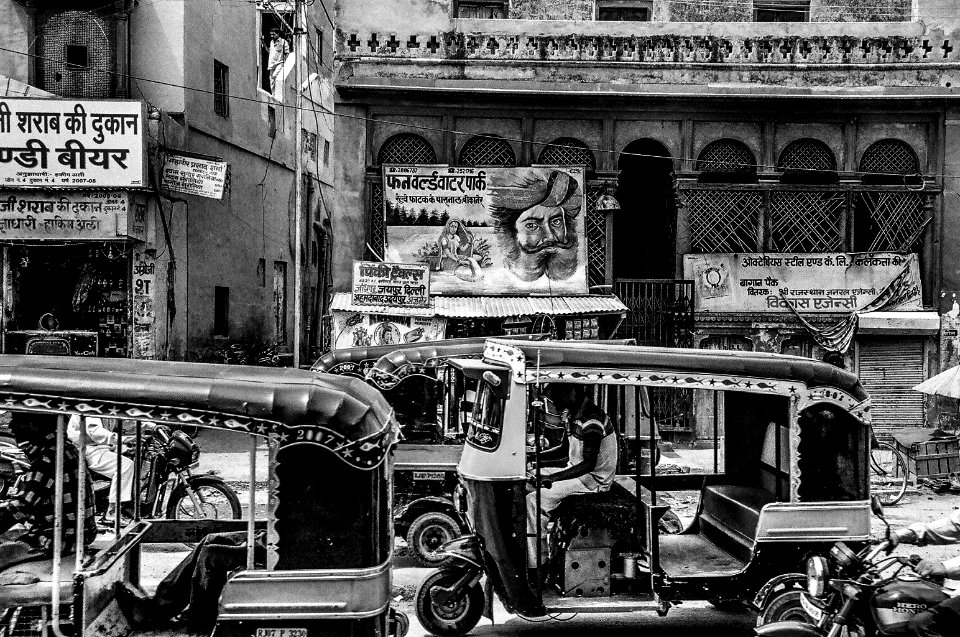greyscale auto rickshaw and people