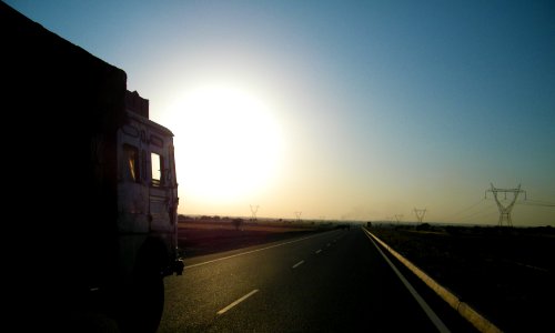 gray truck on asphalt road during sunset photo