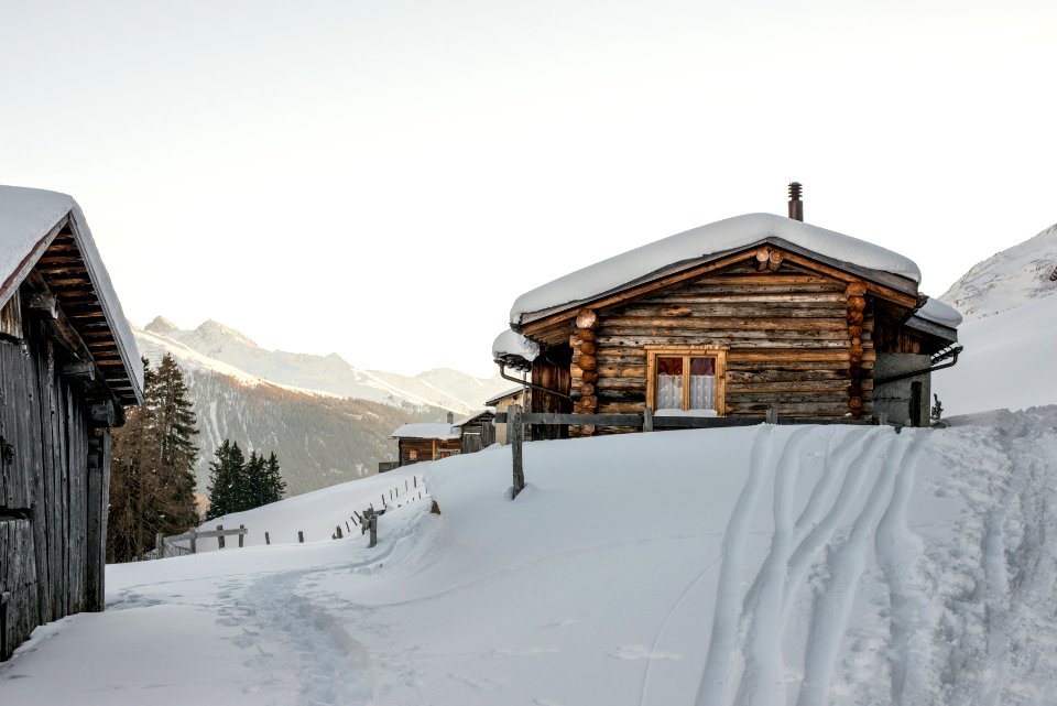snow covered house under white cloudy sky during daytime photo