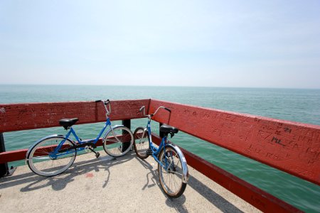 two bicycle parked beside red raiols photo