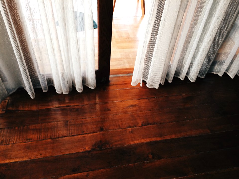two white curtains covering a glass door