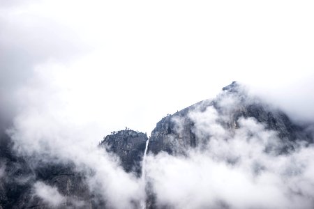 photo of mountain under white clouds at daytime photo