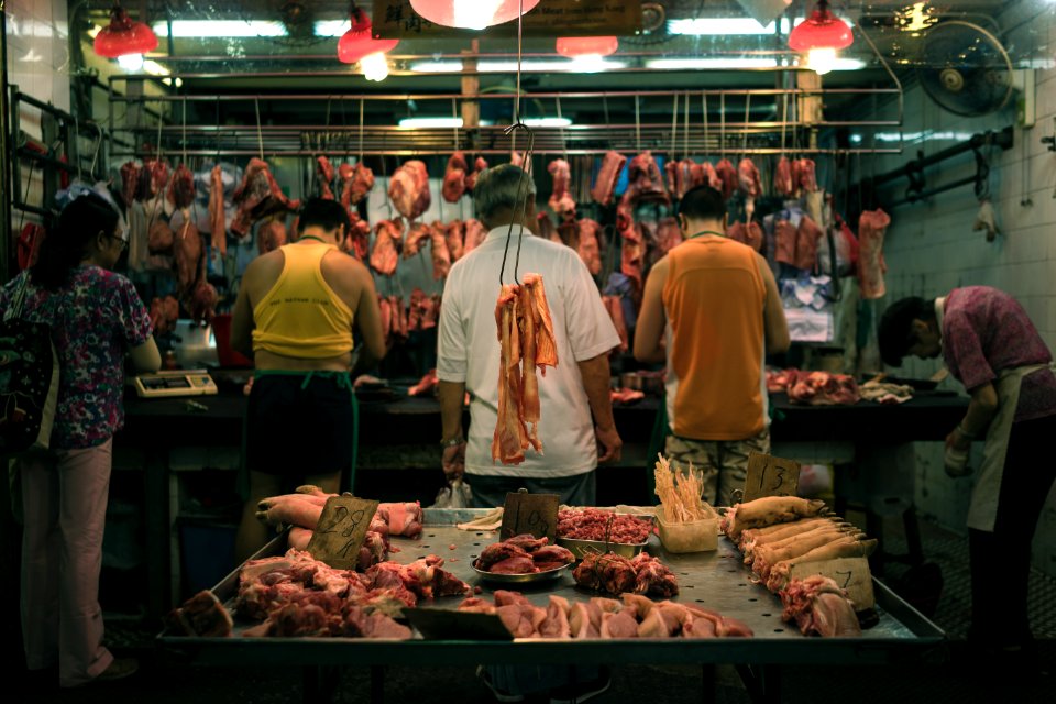 raw meat display behind five person