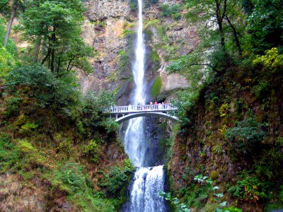 white bridge in front of waterfalls during daytime photo