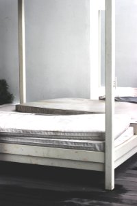 white wooden bed frame photo