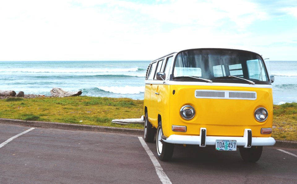 yellow Volkswagen T2 van on concrete road