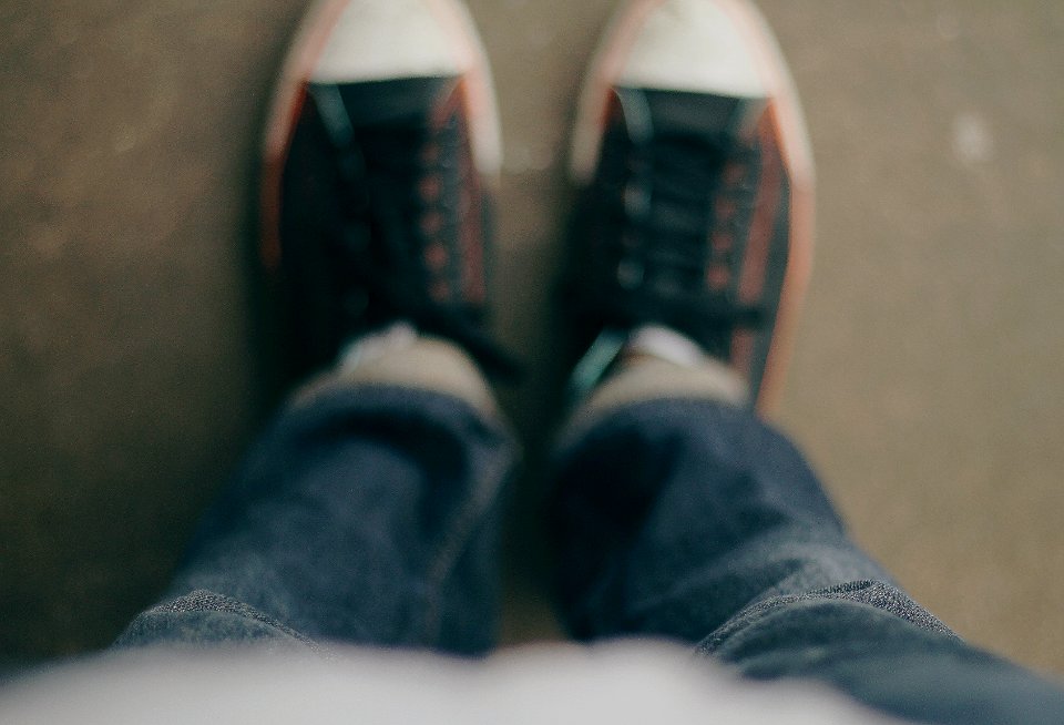 person wearing white-and-black low-top sneakers