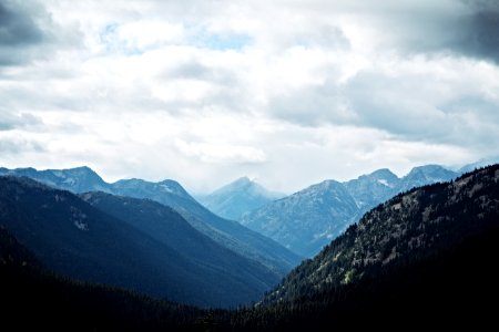 mountains under cloudy skies photo