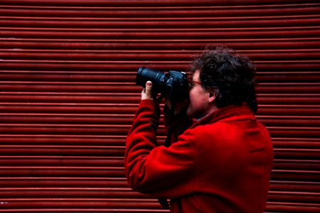 man using black DSLR camera
