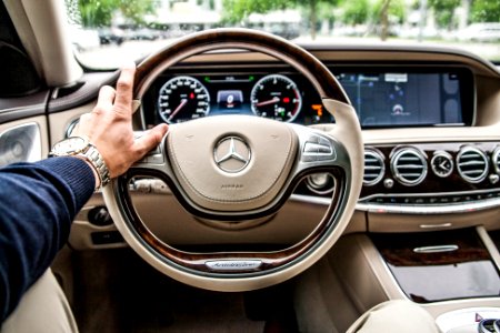 person sitting in Mercedes-Benz driver seat photo